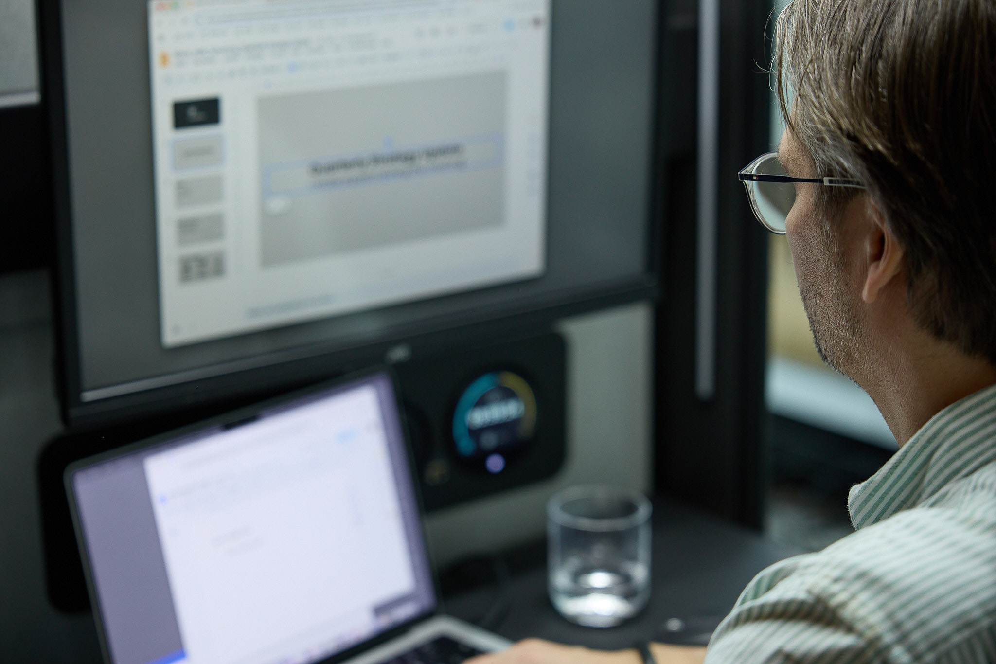 Person working at a monitor inside an acoustic pod