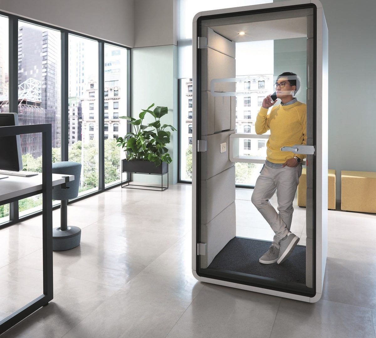 Acoustic fabric, thick laminated glass, gaskets, wool, foam, and other interior materials all safeguard Hush's target 40dB hum. Pictured here is the hushPhone call booth, carefully designed for calls on open floors.
