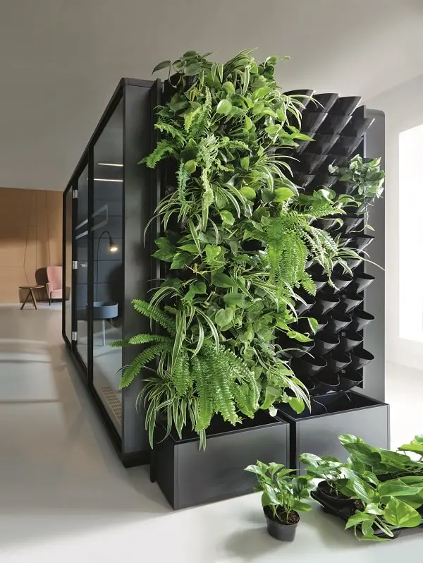 Surfaced with the greenWall system, Hush office work pods and booths filter the office's air.