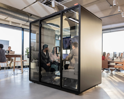 Hush acoustic meeting pod placed in a modern office environment during a team discussion.